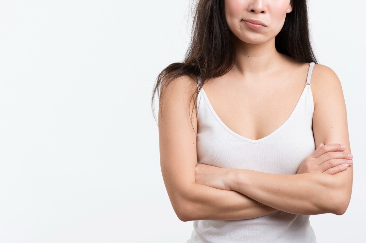 Woman showing natural breast lift results with improved contour and uplift